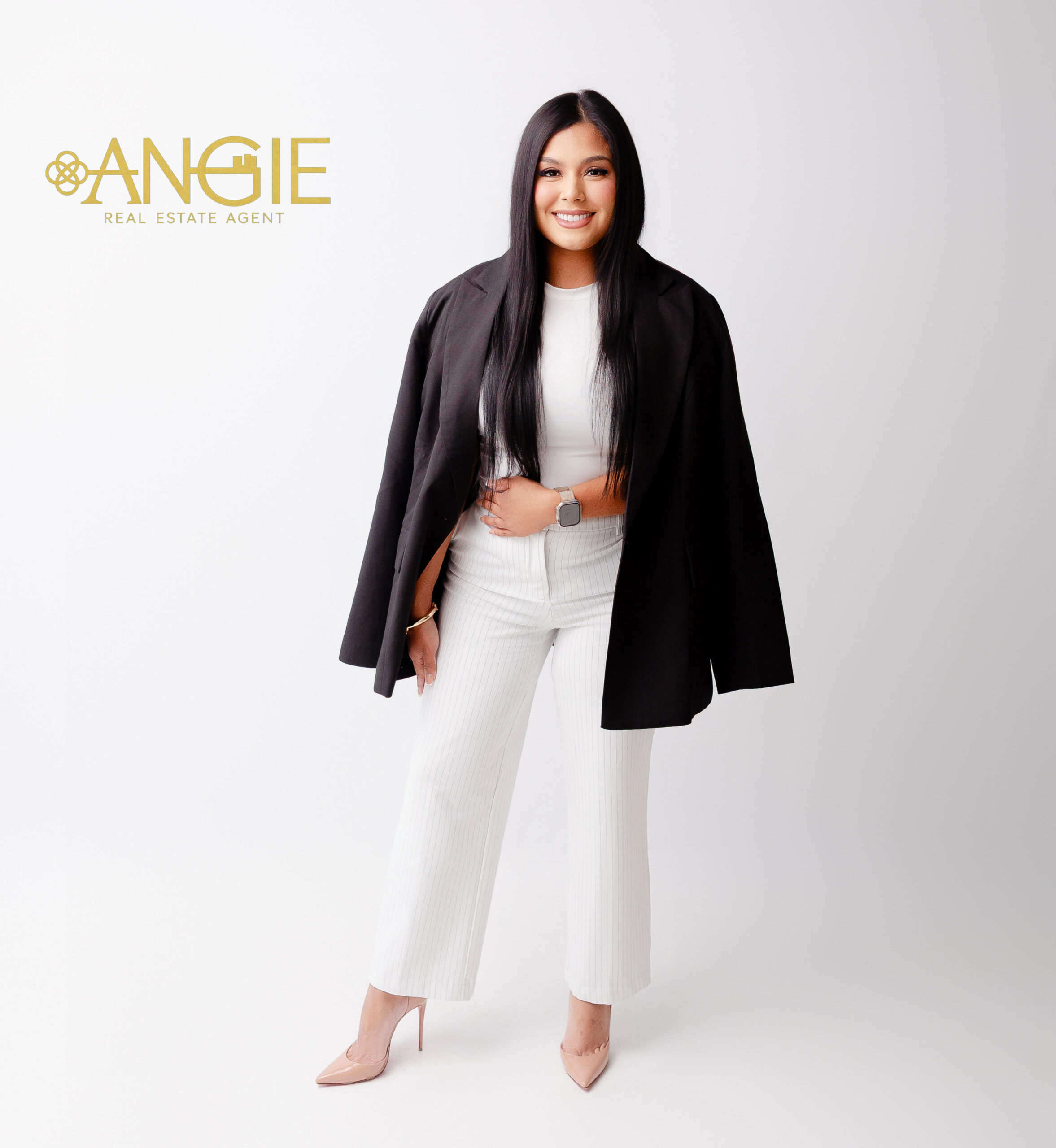 Angie Aguilar in a black blazer, with a renovated kitchen and a Fixer with Potential badge