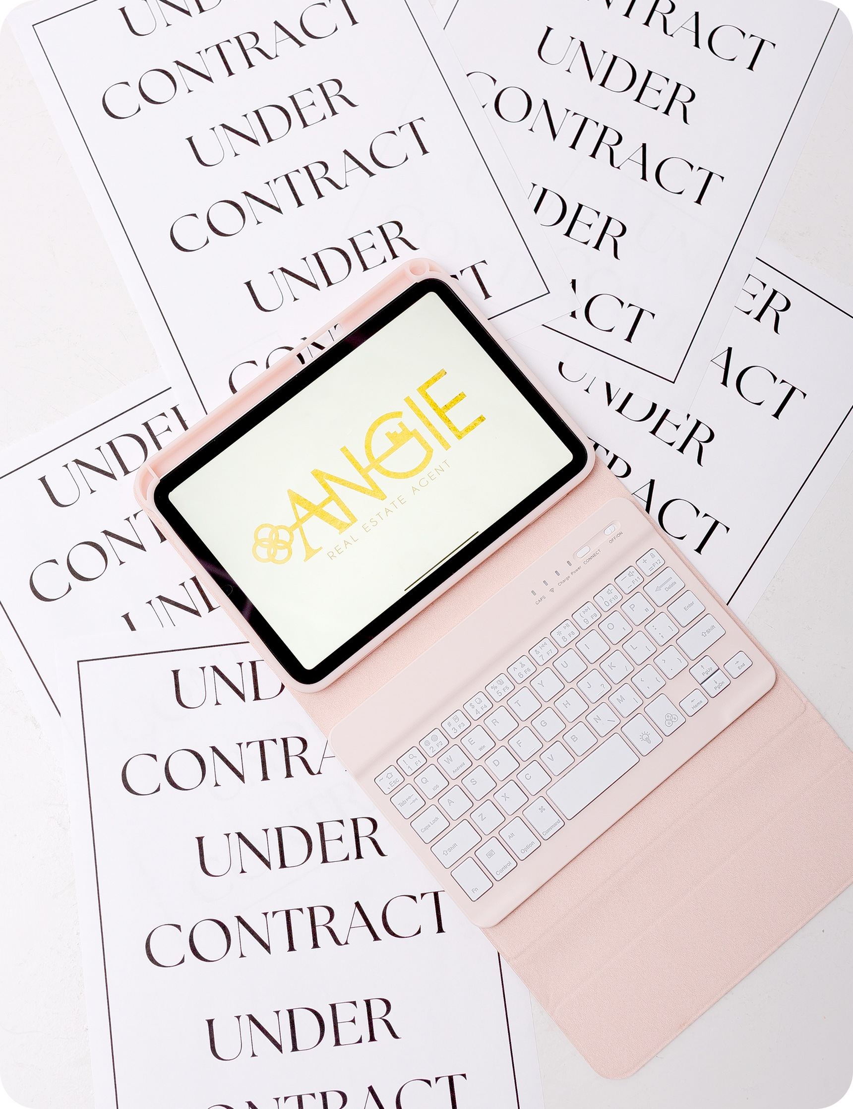 Under Contract papers with a tablet showing the Angie logo