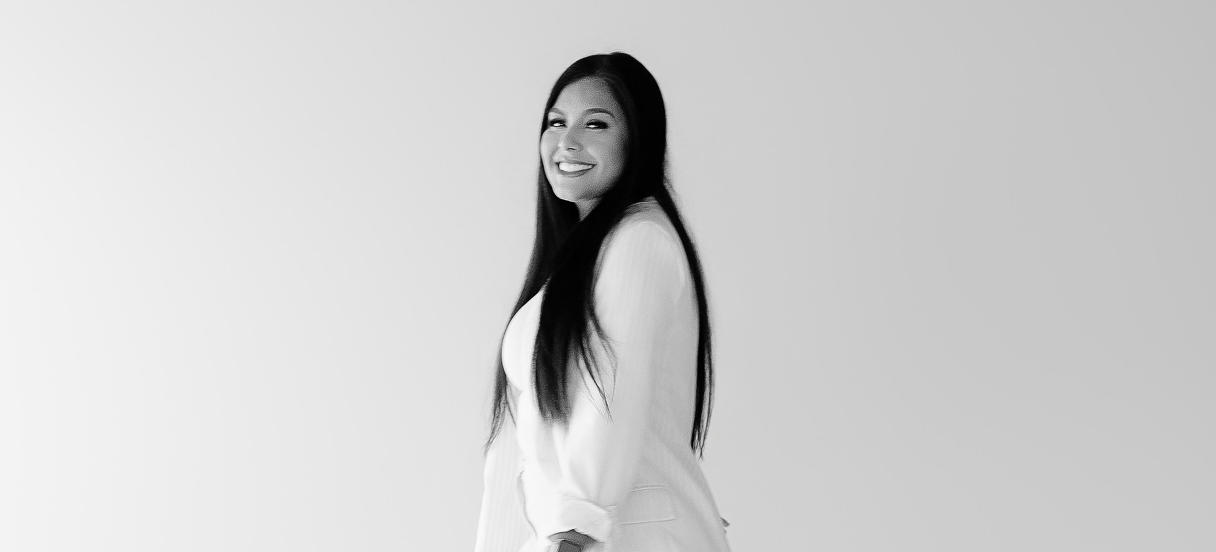 Angie Aguilar smiling, black and white portrait