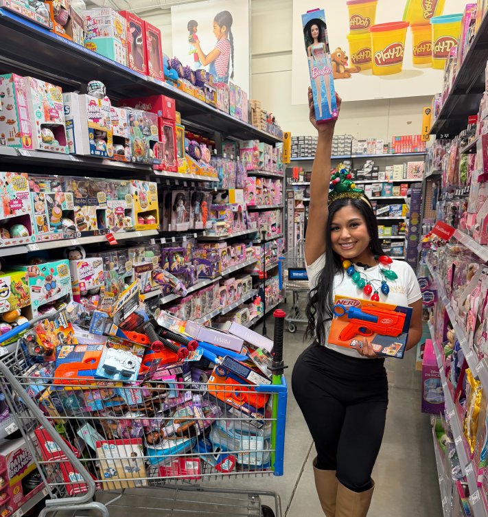 Angie Aguilar holding a toy in a toy store aisle