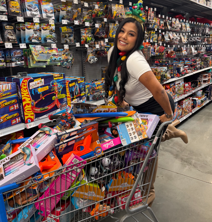 Angie Aguilar with a shopping cart full of toys