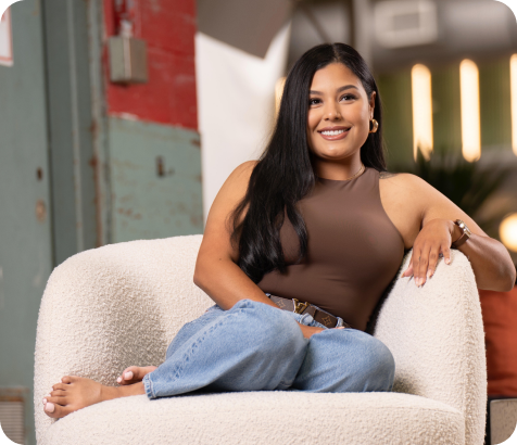 Angie Aguilar seated in a white chair