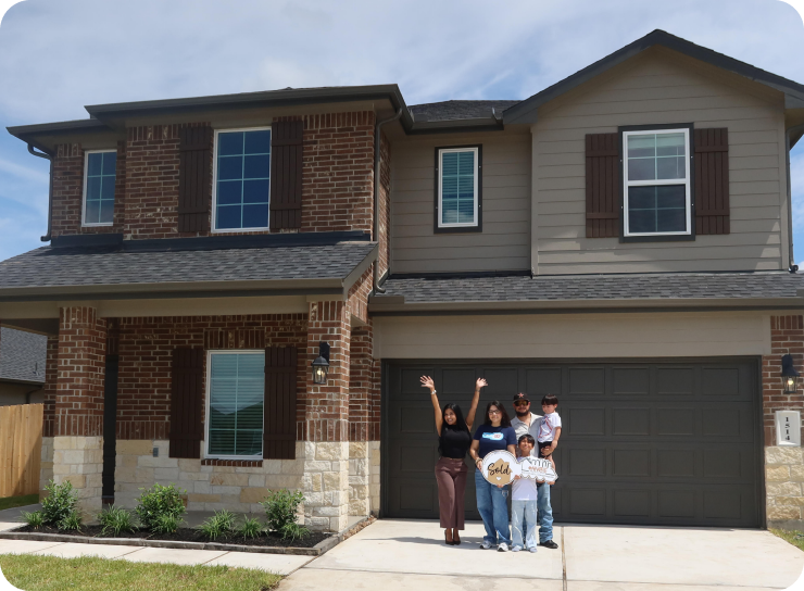Family standing in front of their new two-story brick home