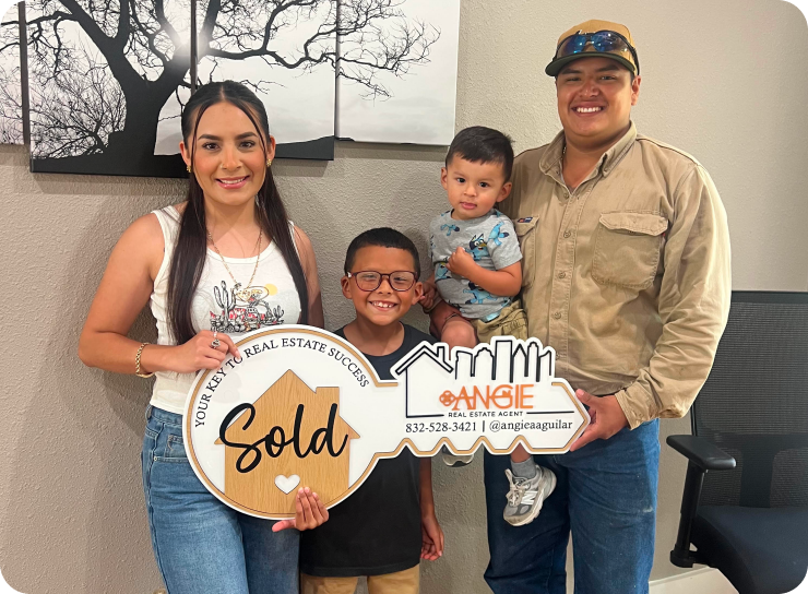 Family holding a Sold key with Angie's team
