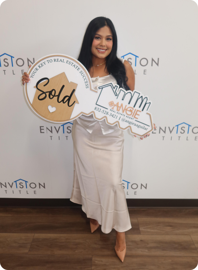 Angie Aguilar holding a Sold key at Envision Title